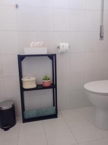 a bathroom with a shelf next to a toilet at B&B Casa Giardino Ferrazzano in Ferrazzano +13 photos