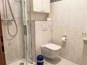 a bathroom with a toilet and a glass shower at Apartment Villa Imperator by Interhome in Ostseebad Sellin