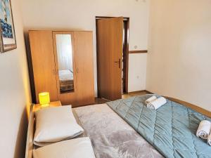 a small bedroom with a bed and a mirror at Holiday Home Vesna by Interhome in Diklo