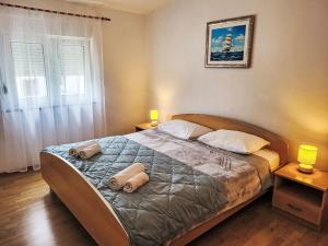 a bedroom with a bed with two pillows on it at Holiday Home Vesna by Interhome in Diklo