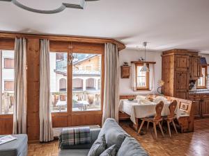 a living room with a table and a large window at Apartment Chesa Mezzaun by Interhome in Zuoz +26 photos