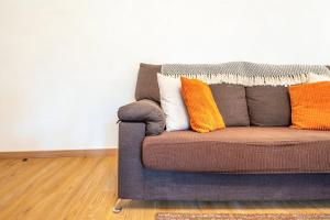 a couch with pillows on it in a living room at GuestReady - Spacious Apt near Cascais City Centre in Alvide +27 photos