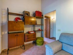 a living room with a couch and a dresser at Apartment Casa Renai a San Gimignano-5 by Interhome in San Gimignano