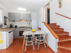 a kitchen with a table and chairs and a staircase at Holiday Home Sascha by Interhome in Peñíscola