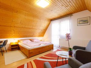 a bedroom with a bed and a wooden ceiling at Holiday Home Emi - BAC110 by Interhome in Badacsonytomaj