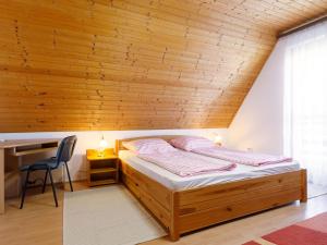 a bed in a room with a wooden ceiling at Holiday Home Emi - BAC110 by Interhome in Badacsonytomaj