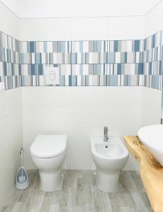 a bathroom with a toilet and a sink at Acqua Marina casa vacanza in Vieste +15 photos
