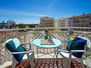 a table and two chairs on a balcony with a table at Apartment Navegante by Interhome in Monte Gordo