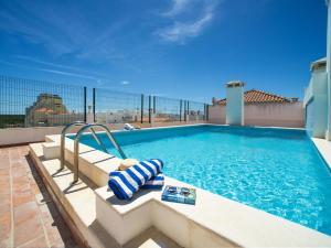 a swimming pool on top of a building at Apartment Navegante by Interhome in Monte Gordo +32 photos