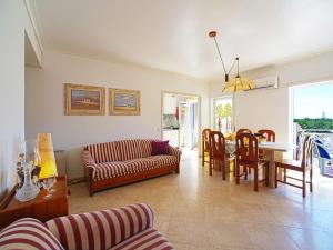 a living room with a couch and a table at Apartment Navegante by Interhome in Monte Gordo