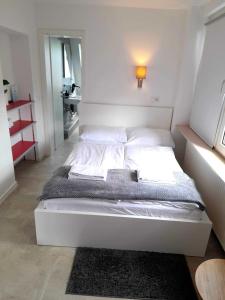 a white bed in a bedroom with a light on it at Stilvolle Apartments in Bonn I home2share in Bonn