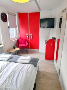 a red room with a bed and a red chair at Stilvolle Apartments in Bonn I home2share in Bonn