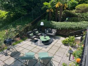 a patio with chairs and a table and a grill at Miralago in Stresa