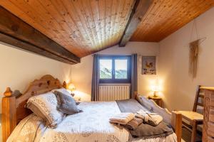 Un dormitorio con una cama con techo de madera. en Chalet Le Grand Nant, en La Giettaz