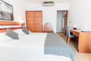 Posteľ alebo postele v izbe v ubytovaní Hotel Horizont