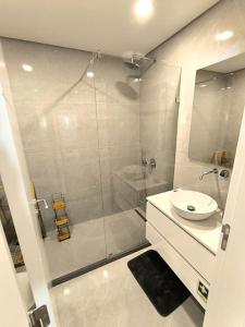 a bathroom with a shower and a toilet and a sink at Full Nathur I Central Ericeira in Ericeira +11 photos