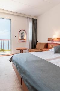 Posteľ alebo postele v izbe v ubytovaní Hotel Horizont