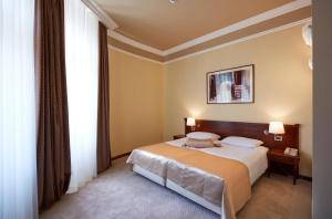 a bedroom with a bed and a large window at BRISTOL Hotel Opatija in Opatija