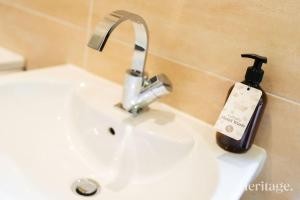 a soap bottle sitting on top of a bathroom sink at Station Cottage Dinnet, Aboyne in Aboyne +37 photos