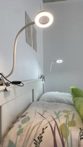 a bedroom with a lamp next to a bed at Best Rated Central Apartment Vienna - AC, WiFi, 24-7 Self Check-In, Board games, Netflix, Prime in Vienna