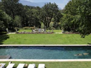 a swimming pool in a yard with lounge chairs at Constantia Klein in Cape Town