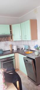 a kitchen with a person laying on the floor at Mieszkanie jednopokojowe in Iława