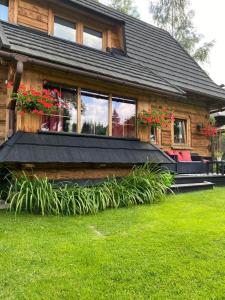 a house with plants in front of it at Apartamenty u Giewonta in Zakopane