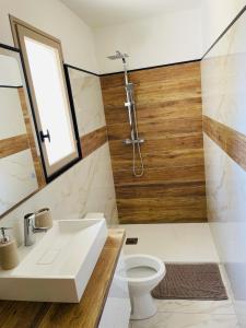 a bathroom with a sink and a toilet at Mini maison entre mer et montagne in Aléria +3 photos