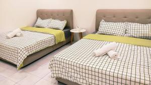 Ένα ή περισσότερα κρεβάτια σε δωμάτιο στο Kulai Tmn Putri Tmn Gunung Pulai Tmn Baiduri Tmn Kota Kulai Tmn Lagenda Kulai 3-5BR near Airport JPO IOI