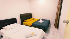 Ένα ή περισσότερα κρεβάτια σε δωμάτιο στο Kulai Tmn Putri Tmn Gunung Pulai Tmn Baiduri Tmn Kota Kulai Tmn Lagenda Kulai 3-5BR near Airport JPO IOI