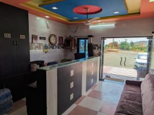 a bar with a view of a parking lot at Maa Madhvadi Hotel & Restaurant in Mātānomadh