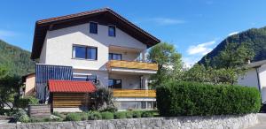 a white house with a red roof at Apartma BoLeRo in Tolmin