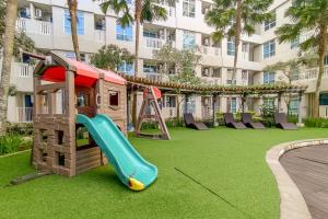 a playground in front of a building with a slide at Borneo Bay City Apartment, 1BR in Klandasan Kecil