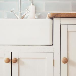 a white kitchen counter with a sink at The Burrow at Burrow Wood Farm in Ottery Saint Mary