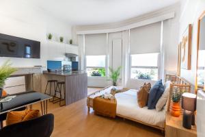 a living room with a couch and a table at Brunswick - Brighton Regency Studio by the sea in Brighton & Hove