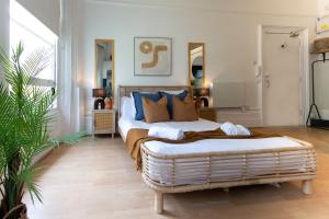 a bedroom with a bed with blue and brown pillows at Brunswick - Brighton Regency Studio by the sea in Brighton & Hove