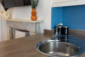 a kitchen counter with a sink and a vase at Brunswick - Brighton Regency Studio by the sea in Brighton & Hove +45 photos