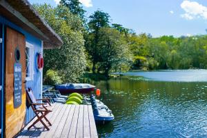 a dock with boats parked on a river at Tiny House Pioneer 2 - Salemer See in Salem