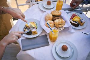 a white table with plates of food on it at BRISTOL Hotel Opatija in Opatija