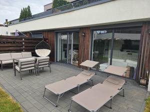 a patio with a bunch of tables and chairs at Przytulne mieszkanie z kominkiem in Opole