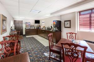 a dining room with a table and chairs and a kitchen at Days Inn by Wyndham Grand Island I-80 in Doniphan