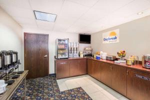 a coffee shop with a counter and aacistacist at Days Inn by Wyndham Grand Island I-80 in Doniphan