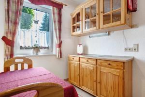 cocina con armario de madera y ventana en Fewo 11 - Halbinsel Darss - Ostsee, en Wieck