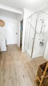 a bathroom with a glass shower in a room at Beach Bungalow Yeppoon in Yeppoon
