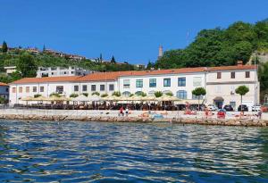 a group of buildings next to a body of water at Ocean Dream by Locap Group in Piran