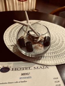 une plaque de verre avec une étoile de mer et des biscuits sur une table dans l'établissement Hotel Maja, à Pescara