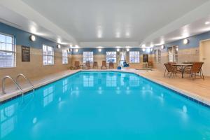 a large swimming pool with a table and chairs at Homewood Suites - Rock Springs in Rock Springs