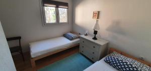 a small bedroom with a bed and a window at Mila in Olib