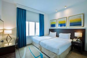 Uma cama ou camas num quarto em Radisson Blu Resort, Fujairah