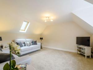 a living room with a white couch and a tv at 1 Bed in Langholm 83343 in Langholm